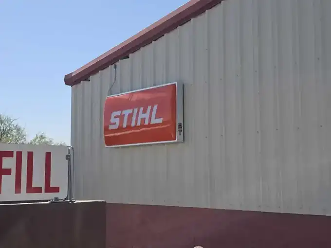 Sign cabinet mounted and fed from a weather-rated conduit run.