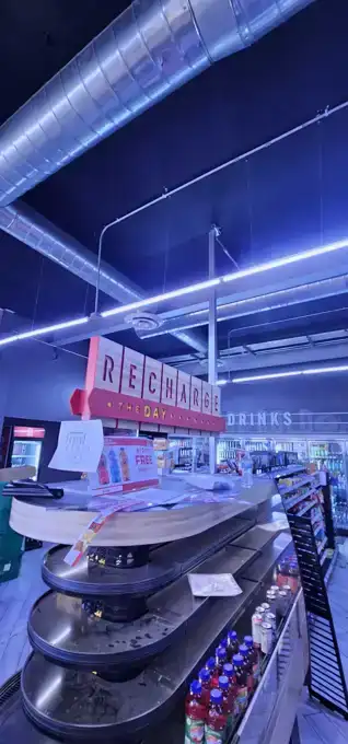Backlit beverage station and accent lighting on the sales floor.