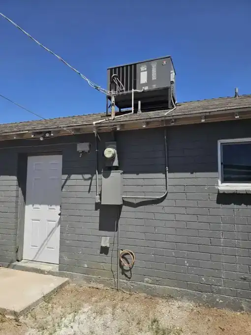 Before — original meter, undersized service and an aging exterior panel.