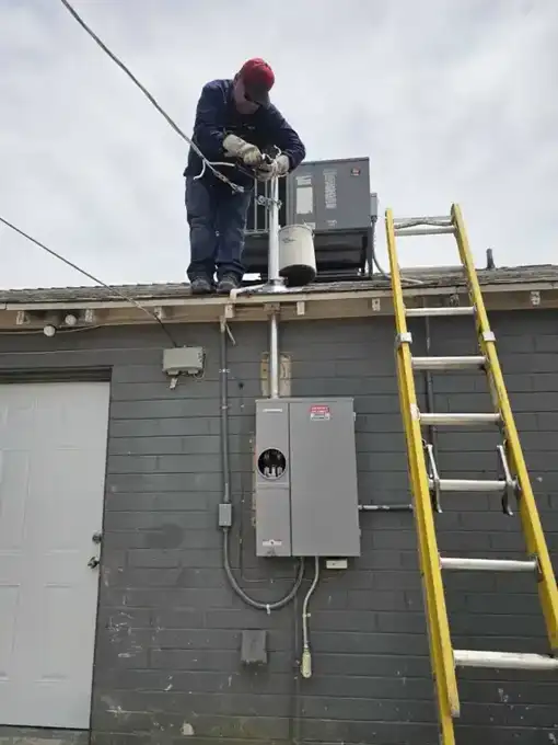 Utility crew reconnecting the new service riser we installed.