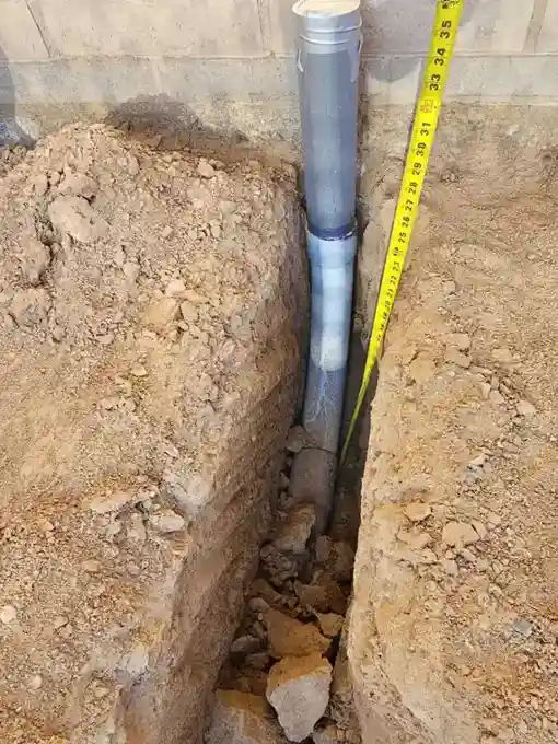 Trenching the new underground feeder run to depth.