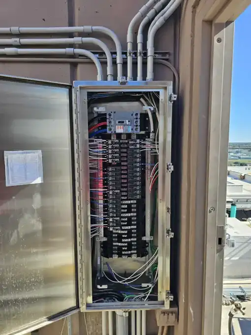 New panel inside a stainless NEMA 4X enclosure, circuit directory filled in.