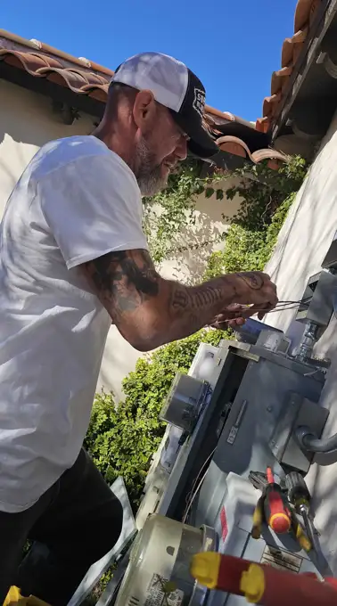 B and D Electric technician working on a residential meter and panel in Phoenix